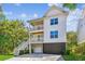 Stunning three-story home with double balconies and stairway leading to the ground level at 5035 Gum Tree Ln, Johns Island, SC 29455