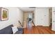Hallway with gleaming hardwood floors, access to the living area, and a safety gate at 5035 Gum Tree Ln, Johns Island, SC 29455