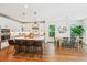 Open kitchen with island, pendant lighting, and stainless appliances flowing into the dining area at 5035 Gum Tree Ln, Johns Island, SC 29455