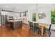 Bright, open kitchen with an island, stainless steel appliances and a dining area at 5035 Gum Tree Ln, Johns Island, SC 29455