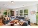 Sunlit living room featuring comfortable seating, hardwood floors, and access to outdoor deck, ideal for relaxation at 5035 Gum Tree Ln, Johns Island, SC 29455