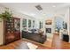 Cozy living room boasts natural light, a fireplace, and hardwood flooring at 5035 Gum Tree Ln, Johns Island, SC 29455