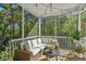 Relaxing screened porch with comfortable seating and scenic views of surrounding trees at 5035 Gum Tree Ln, Johns Island, SC 29455