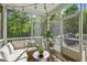 Relaxing screened porch with comfortable seating and scenic views of surrounding trees at 5035 Gum Tree Ln, Johns Island, SC 29455