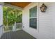 Charming porch view with wooded landscape, exterior light, and wood ceiling at 5035 Gum Tree Ln, Johns Island, SC 29455