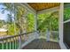 Cozy porch with wooden floor, white railings, and beautiful nature views at 5035 Gum Tree Ln, Johns Island, SC 29455