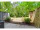 Backyard featuring a privacy fence, green foliage, and an air conditioning unit at 507 Stinson Dr # 7F, Charleston, SC 29407