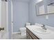 Well-lit bathroom with blue walls, marble flooring, vanity, and shower tub at 507 Stinson Dr # 7F, Charleston, SC 29407