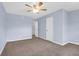 Spacious bedroom with light blue walls, neutral carpet, and a connecting door at 507 Stinson Dr # 7F, Charleston, SC 29407
