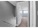 Hallway with gray walls leading to a bedroom with a window and blue walls at 507 Stinson Dr # 7F, Charleston, SC 29407