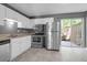 Charming kitchen featuring stainless steel appliances and sliding glass doors to backyard at 507 Stinson Dr # 7F, Charleston, SC 29407