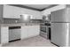 Well-equipped kitchen with modern stainless steel appliances and sleek white cabinets at 507 Stinson Dr # 7F, Charleston, SC 29407
