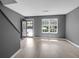 Bright living room with new laminate flooring, grey walls, and lots of natural light at 507 Stinson Dr # 7F, Charleston, SC 29407