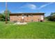 Backyard with a well-kept lawn and traditional brick house featuring dual entrances with steps at 65 University Dr, Ladson, SC 29456