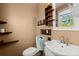 Charming bathroom with floating shelves, vanity with basin sink, and tiled backsplash at 65 University Dr, Ladson, SC 29456