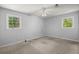 Spacious bedroom with carpeted flooring, ceiling fan, and two large windows at 65 University Dr, Ladson, SC 29456