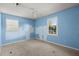 Bright bedroom features dual windows, ceiling fan, and carpeted flooring at 65 University Dr, Ladson, SC 29456