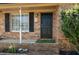 A classic front door with black shutters, complemented by green plants at 65 University Dr, Ladson, SC 29456