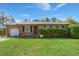 Charming single-story brick home with a well-maintained lawn and manicured bushes at 65 University Dr, Ladson, SC 29456