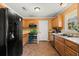 Functional kitchen featuring wooden cabinetry, modern appliances, and tile flooring at 65 University Dr, Ladson, SC 29456