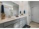 Bathroom features double sinks, modern fixtures, neutral paint and a framed mirror at 706 Squire Pope Rd, Summerville, SC 29486