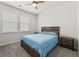 Bright bedroom features a ceiling fan, sunny windows, and a comfortable bed with bedside table at 706 Squire Pope Rd, Summerville, SC 29486