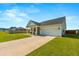 Home showcasing a long driveway, two-car garage, covered porch, and manicured front yard at 706 Squire Pope Rd, Summerville, SC 29486