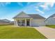 Inviting home featuring a two-car garage and covered front porch, offering comfortable curb appeal at 706 Squire Pope Rd, Summerville, SC 29486