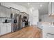 Bright kitchen features stainless steel appliances, light gray cabinets, and gorgeous wood-look floors at 706 Squire Pope Rd, Summerville, SC 29486