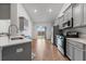 Contemporary kitchen with stainless steel appliances, subway tile backsplash, and an open layout leading to the dining area at 706 Squire Pope Rd, Summerville, SC 29486