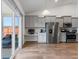 Bright kitchen with gray cabinets, stainless appliances, and a built-in desk near the sliding glass door at 706 Squire Pope Rd, Summerville, SC 29486