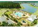 Aerial view of neighborhood pool featuring multiple pools, lounge chairs, playground, and lake at 706 Squire Pope Rd, Summerville, SC 29486