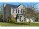 Charming two-story home featuring a well-manicured lawn, attached garage, and classic black shutters at 712 Bent Hickory Rd, Charleston, SC 29414