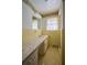 Vintage bathroom with yellow tile, floral wallpaper border and marble countertop at 731 Pitt St, Mount Pleasant, SC 29464