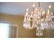 Elegant crystal chandelier fixture casting a warm glow in the dining room, adding a touch of sophistication at 731 Pitt St, Mount Pleasant, SC 29464