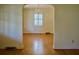 Open dining room with gleaming hardwood floors, chandelier, and arched doorway, perfect for entertaining at 731 Pitt St, Mount Pleasant, SC 29464