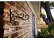 Brick exterior of the home featuring an iron bracket and white painted trim at 731 Pitt St, Mount Pleasant, SC 29464