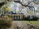Charming brick home featuring a covered porch, dormer windows, and a well-manicured front yard at 731 Pitt St, Mount Pleasant, SC 29464