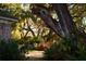 Home exterior with brick facade framed by lush landscaping, and Spanish moss-draped trees at 731 Pitt St, Mount Pleasant, SC 29464
