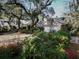 Aerial view of home featuring a brick facade with an attached two-car garage and lush landscaping at 731 Pitt St, Mount Pleasant, SC 29464