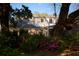 Charming home exterior, showcasing a brick facade complemented by a lush garden filled with vibrant azaleas at 731 Pitt St, Mount Pleasant, SC 29464