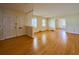 Spacious, light-filled living room with gleaming hardwood floors, white trim, and inviting double front doors at 731 Pitt St, Mount Pleasant, SC 29464