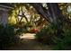 Lush front yard with mature trees, azaleas, and brick walkway, offering charm and curb appeal at 731 Pitt St, Mount Pleasant, SC 29464