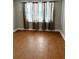 Bedroom featuring hardwood floors, neutral wall color, and a window with curtains at 7724 Linsley Dr, North Charleston, SC 29418