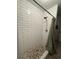 Updated shower with subway tile and decorative pebble floor at 7724 Linsley Dr, North Charleston, SC 29418