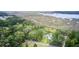 Beautiful marsh view lot surrounded by mature trees, a road, and a white house next door at 791 Hughes Rd, Johns Island, SC 29455