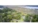 Beautiful marsh view lot surrounded by mature trees, a road, and a house next door at 791 Hughes Rd, Johns Island, SC 29455