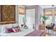 Cozy bedroom showcasing a decorative tapestry, natural window blinds, and a comfortable rattan-style bed frame at 791 Hughes Rd, Johns Island, SC 29455
