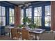 Elegant dining room with navy walls, large windows, and a modern chandelier above a wooden table at 791 Hughes Rd, Johns Island, SC 29455