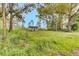 Image of an older house with overgrown weeds and grass and plenty of trees at 791 Hughes Rd, Johns Island, SC 29455